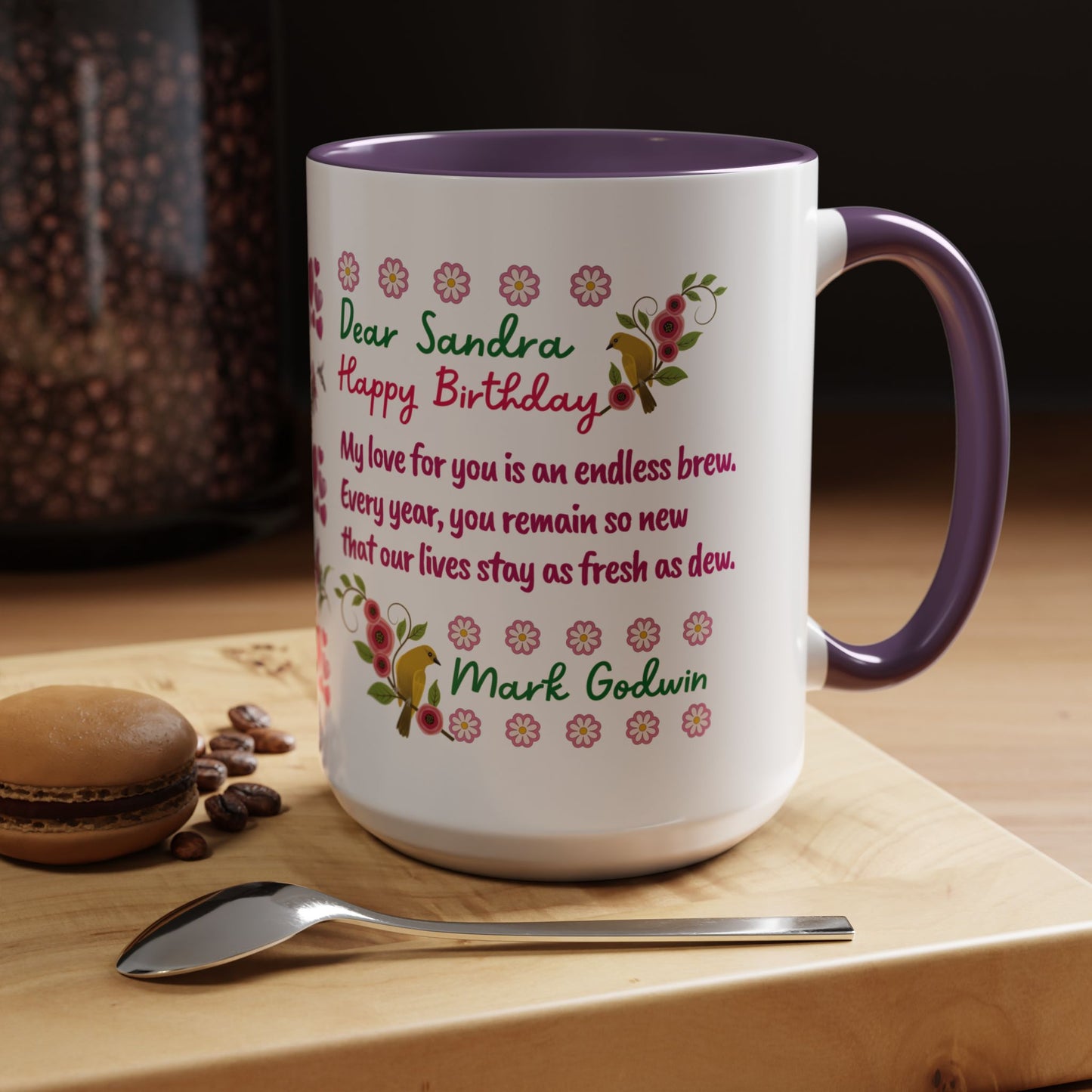 Personalized Birthday Mug for Wives. Personalized mug with floral design and birthday message on a wooden surface with coffee beans and a macaron.