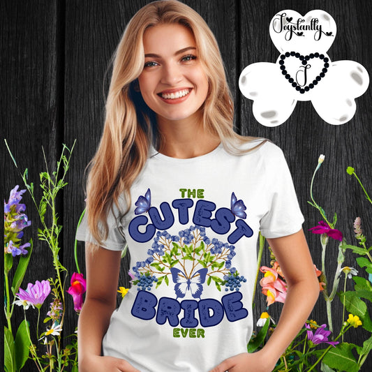 Woman wearing a 'The Cutest Bride Ever' t-shirt with floral and butterfly design, surrounded by flowers and plants.