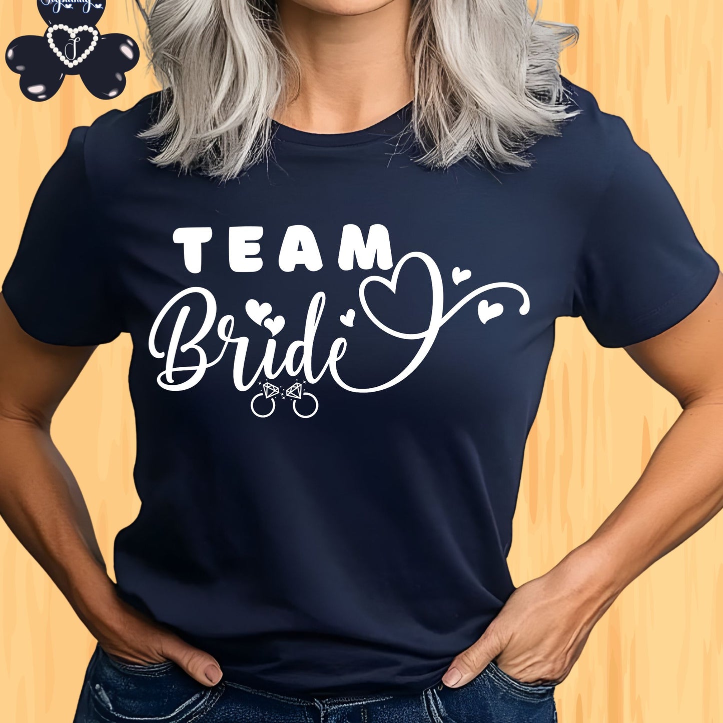 Shirt for Engagements, Bachelorettes, Hen and Bridal Parties. Navy blue t-shirt with 'Team Bride' text worn by a person on a wooden background