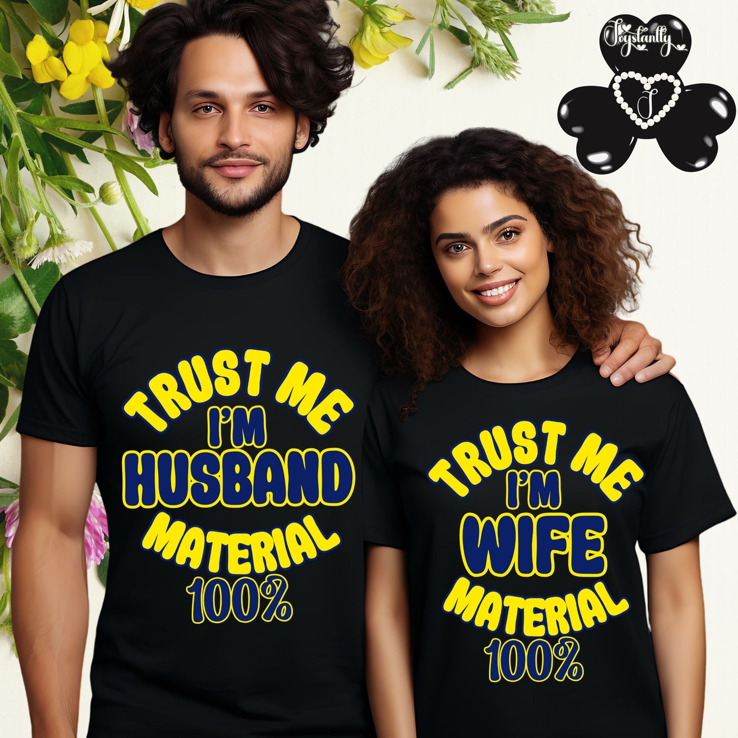 Two people wearing black t-shirts with yellow text, standing in front of a floral background.