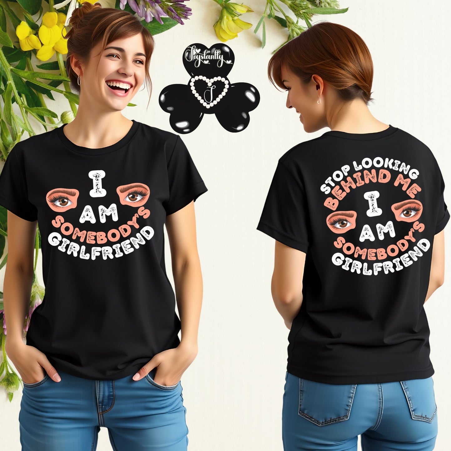 Person wearing a black t-shirt with a colorful design on the front and back, featuring text and eye graphics.