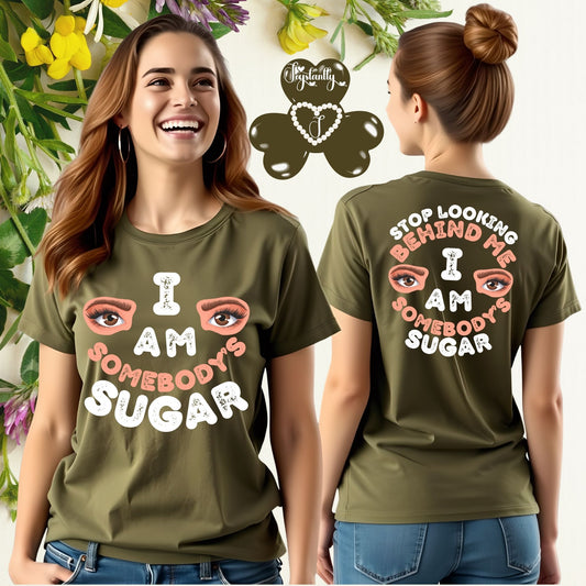 Woman wearing an olive green t-shirt with a motivational message, surrounded by flowers and leaves.