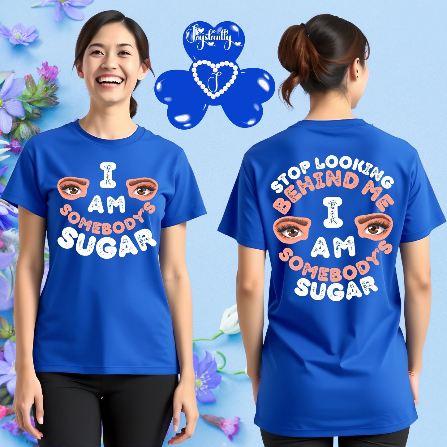 Person wearing a blue t-shirt with text and eye graphics, standing against a floral background.