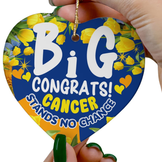 Cancer Motivational Ceramic Ornament of Victory. Heart-shaped blue and yellow card with 'Big Congrats! Cancer Stands No Chance' text, held by a hand.