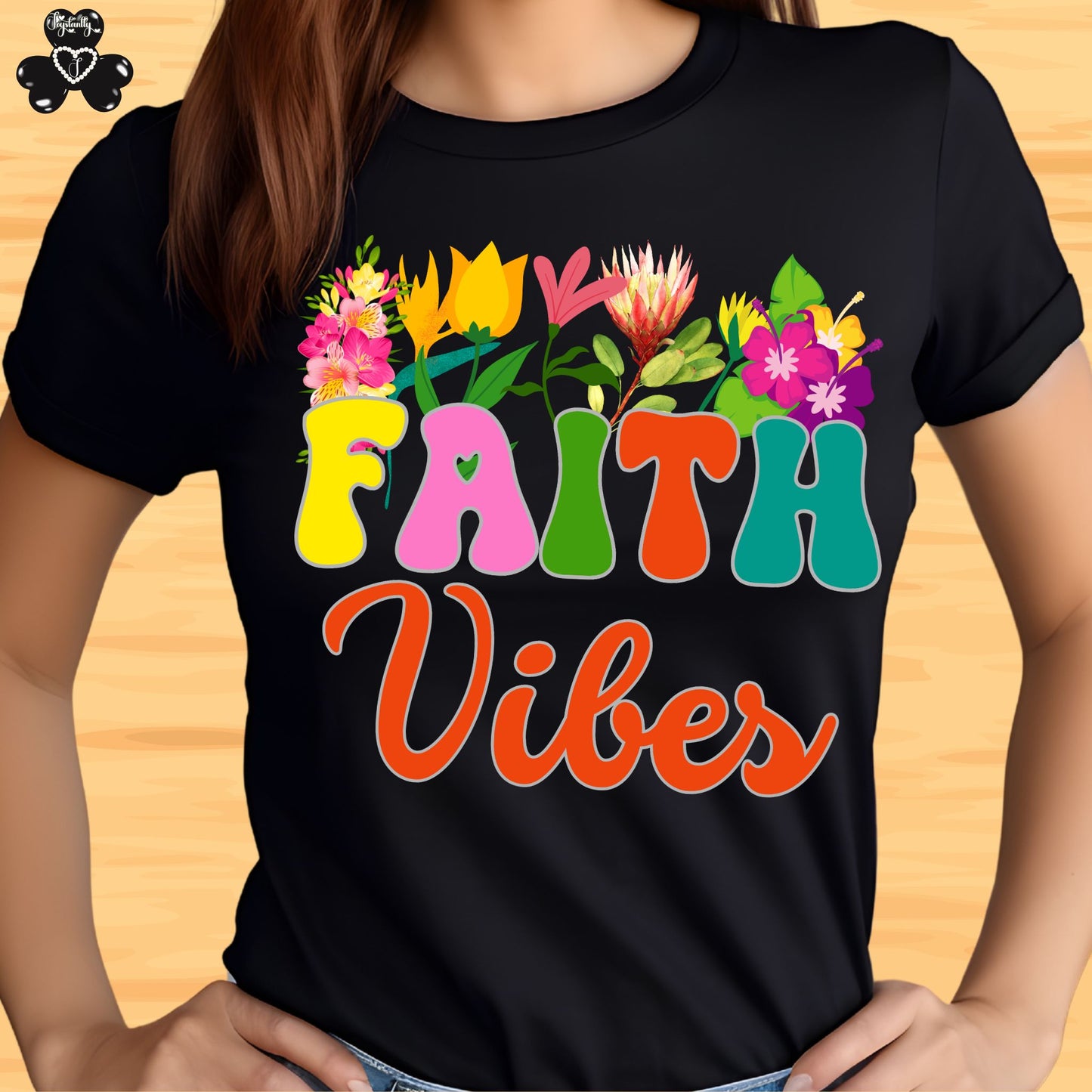Motivational T-shirt for positive affirmations. Black t-shirt with colorful 'Faith Vibes' design on a wooden surface