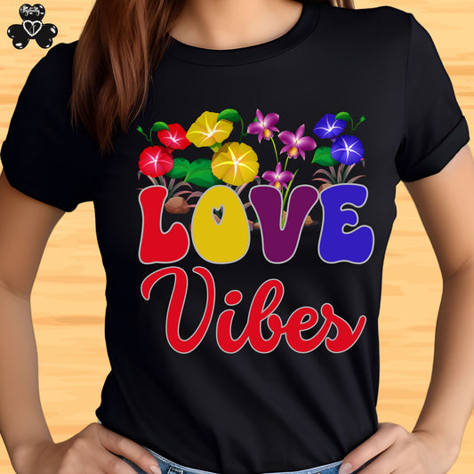Motivational T-shirt for positive affirmations. Black t-shirt with colorful 'LOVE Vibes' design on a wooden surface