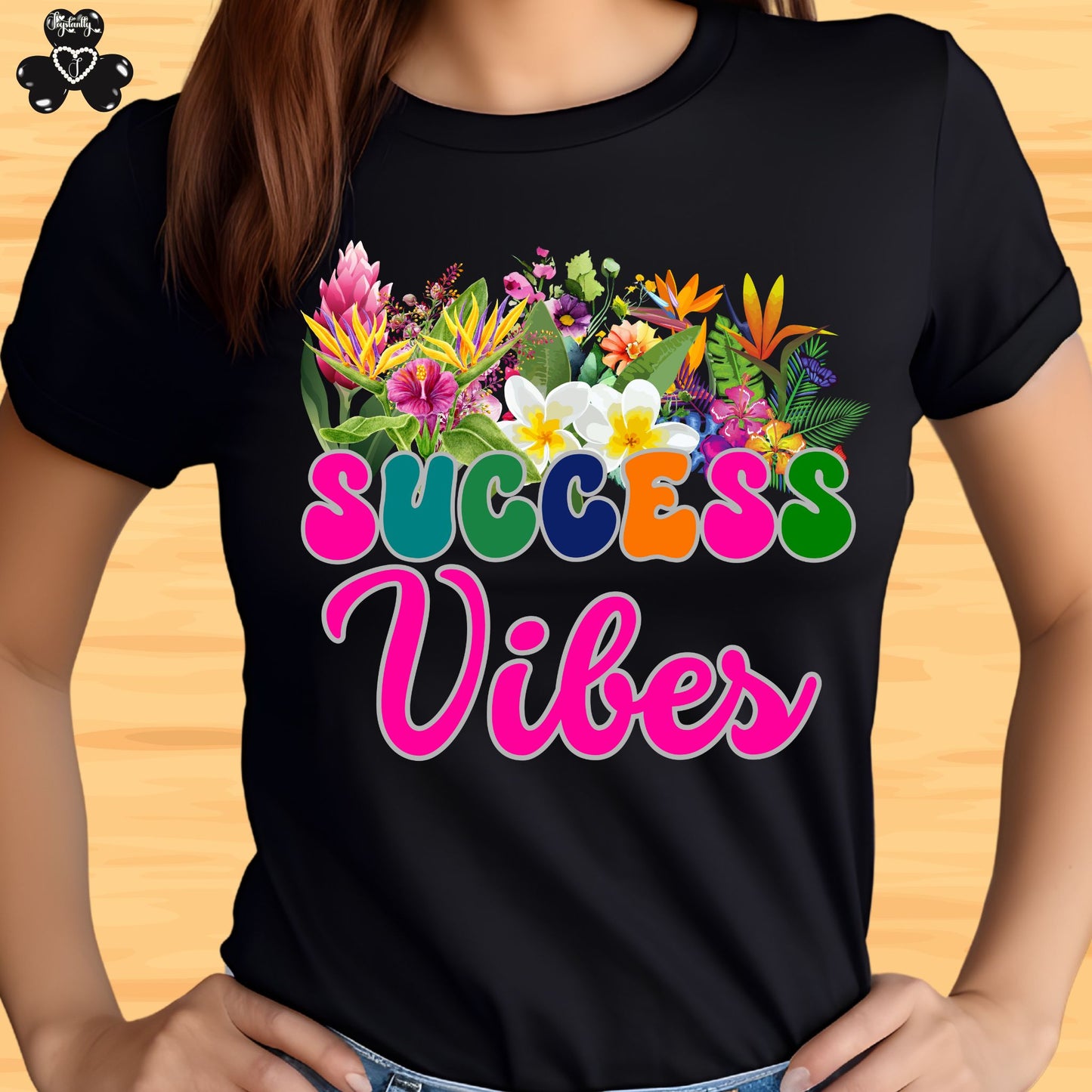 Motivational T-shirt for positive affirmations. Black t-shirt with colorful floral design and 'SUCCESS Vibes' text on a wooden surface