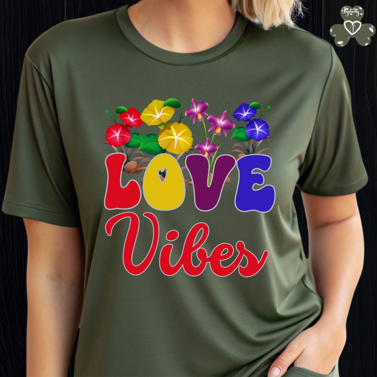 Motivational T-shirt for positive affirmations. Person wearing a green t-shirt with colorful 'LOVE Vibes' design.