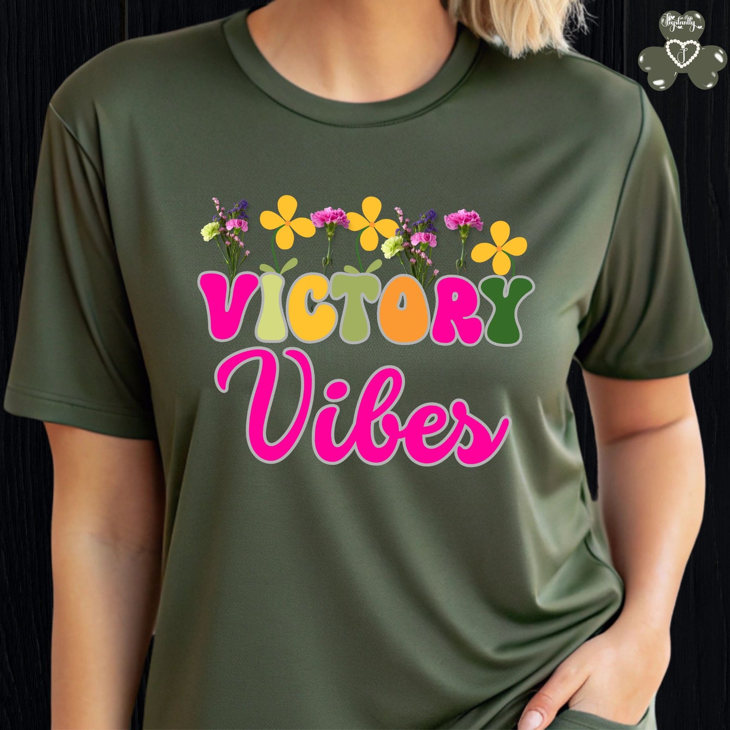 Motivational T-shirt for positive affirmations. Green t-shirt with 'Victory Vibes' and floral design on a black background