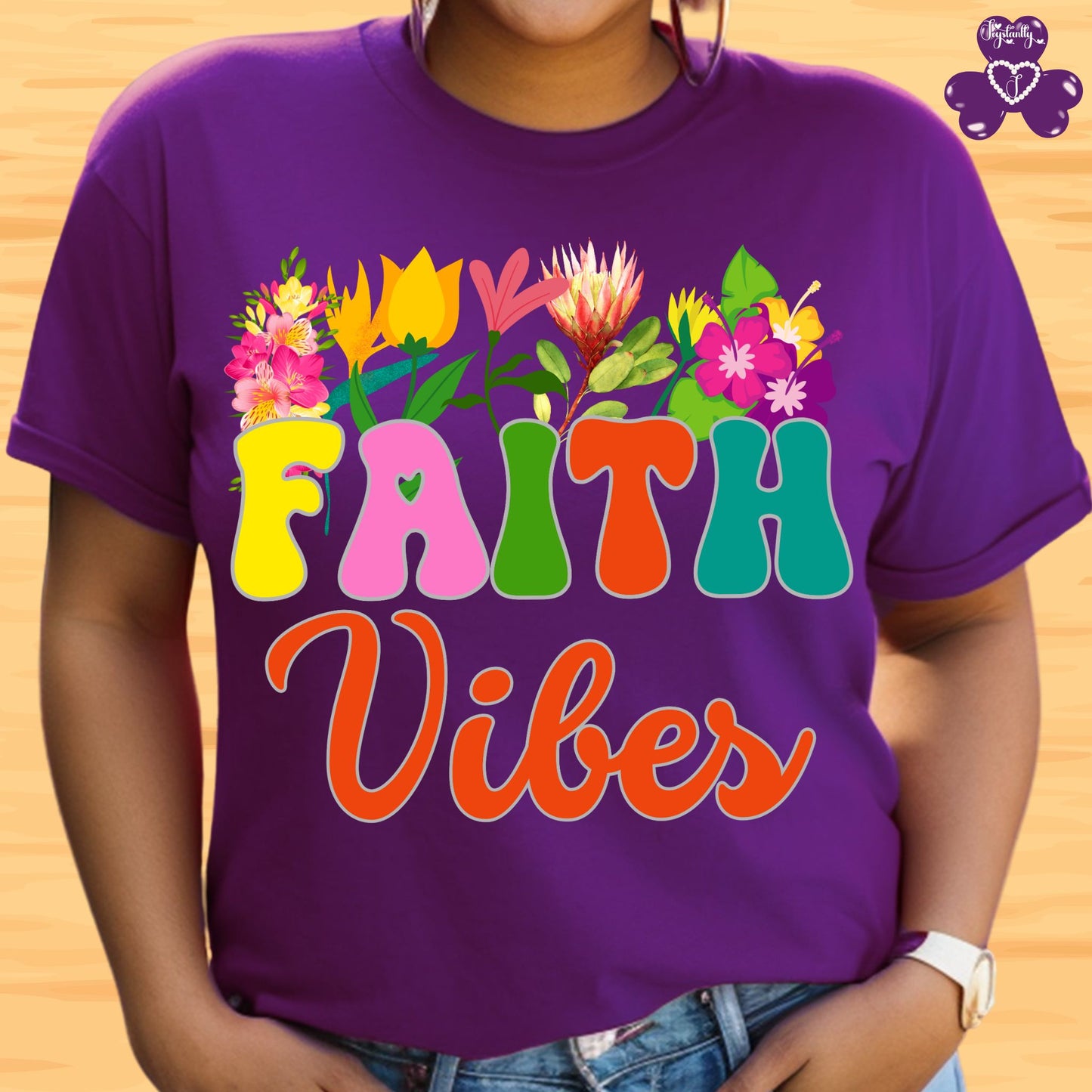 Motivational T-shirt for positive affirmations. Purple t-shirt with colorful 'FAITH Vibes' design on a wooden background