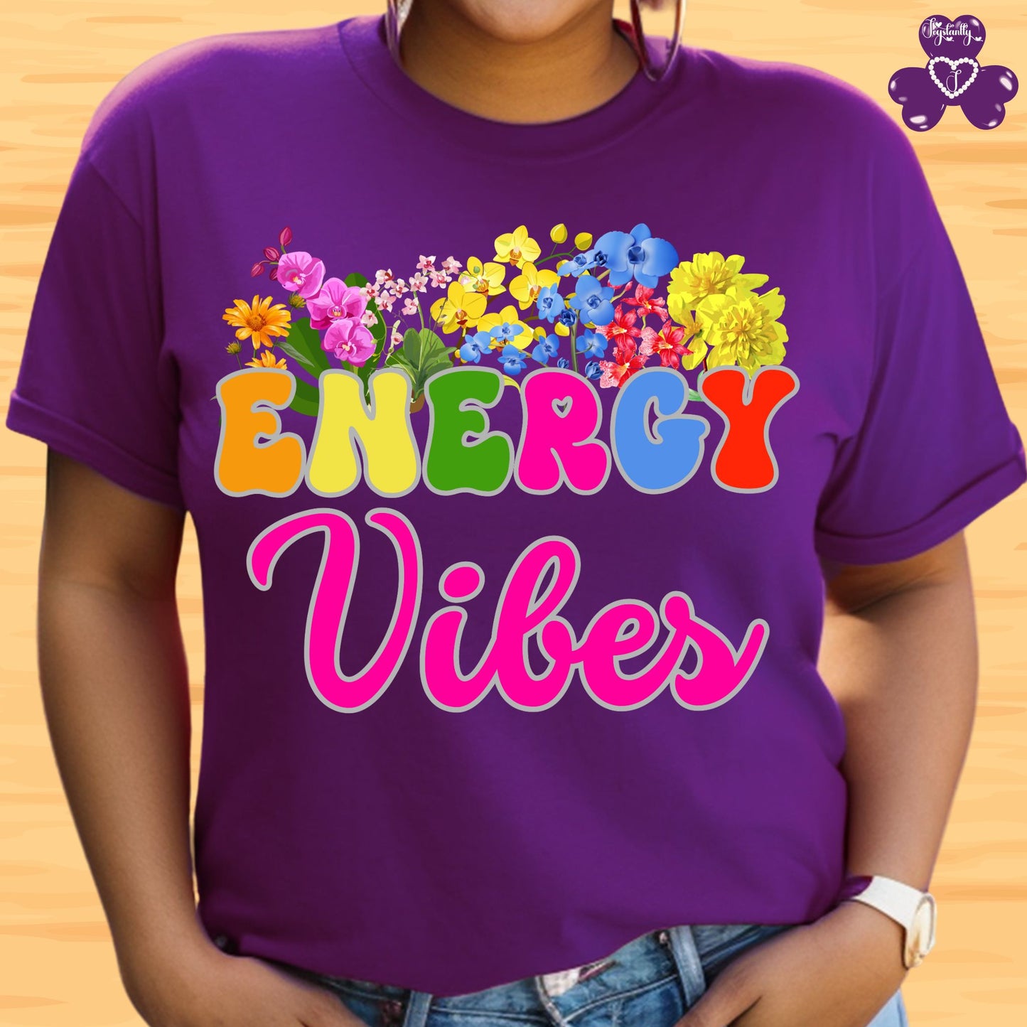 Motivational T-Shirt. Purple t-shirt with 'ENERGY Vibes' and colorful flowers on a wooden background