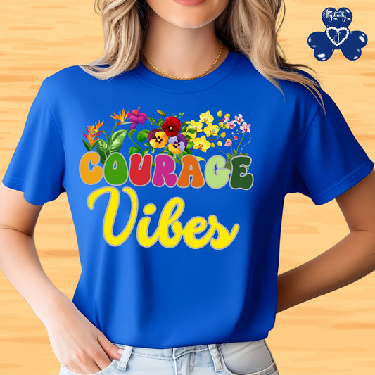 Motivational shirt. Person wearing a blue t-shirt with colorful text and flowers on a wooden background