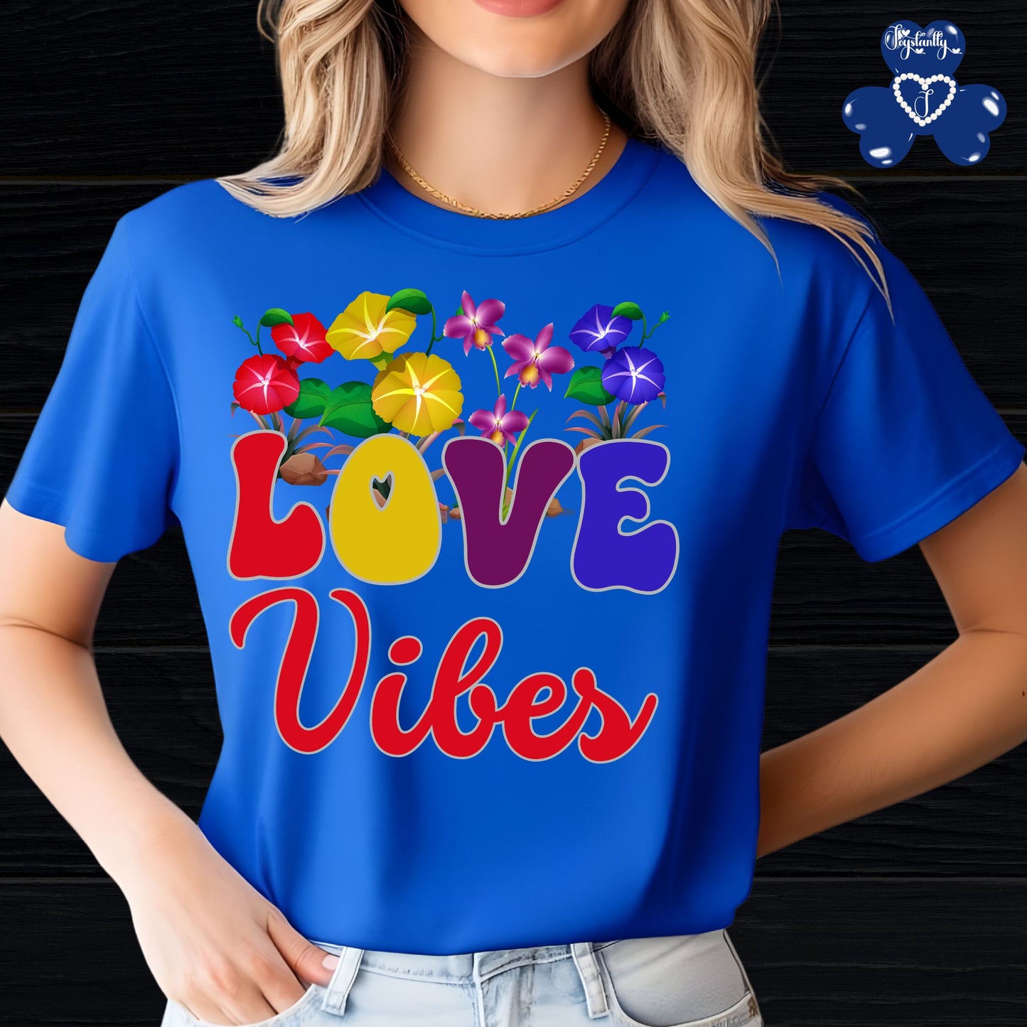 Motivational Shirts for Positive Affirmations. Person wearing a blue t-shirt with colorful 'LOVE Vibes' design