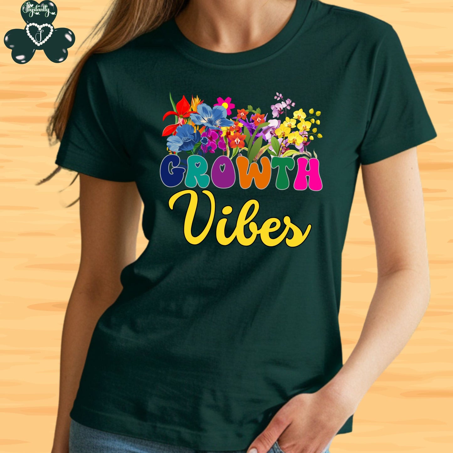 Motivational T-shirt for positive affirmations. Person wearing a green t-shirt with 'Growth Vibes' and colorful flowers design on a wooden background