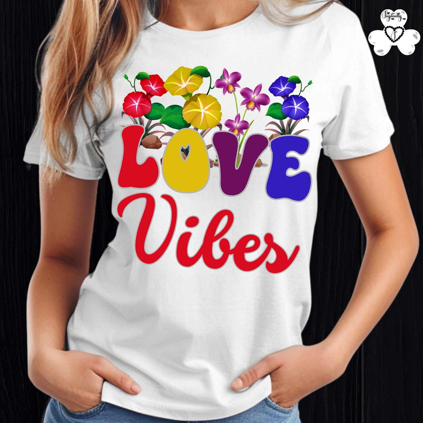 Motivational T-shirt for positive affirmations. White t-shirt with colorful floral design and 'LOVE Vibes' text on a black background