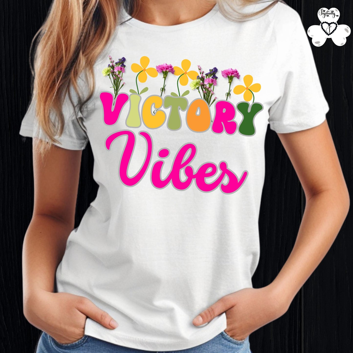 Motivational T-shirt for positive affirmations. White t-shirt with 'Victory Vibes' text and colorful flowers on a black background