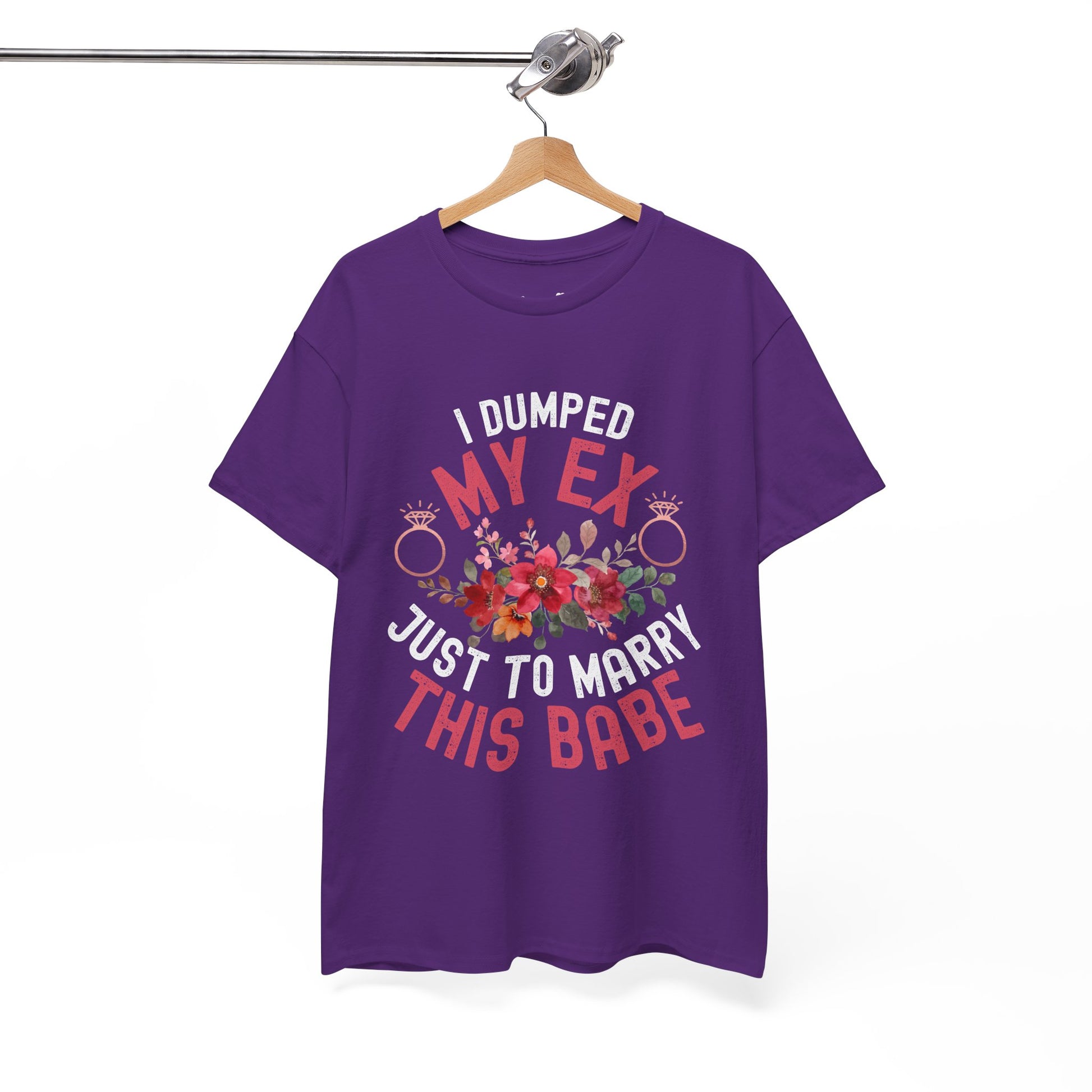 Purple t-shirt with humorous text design on a hanger against a white background
