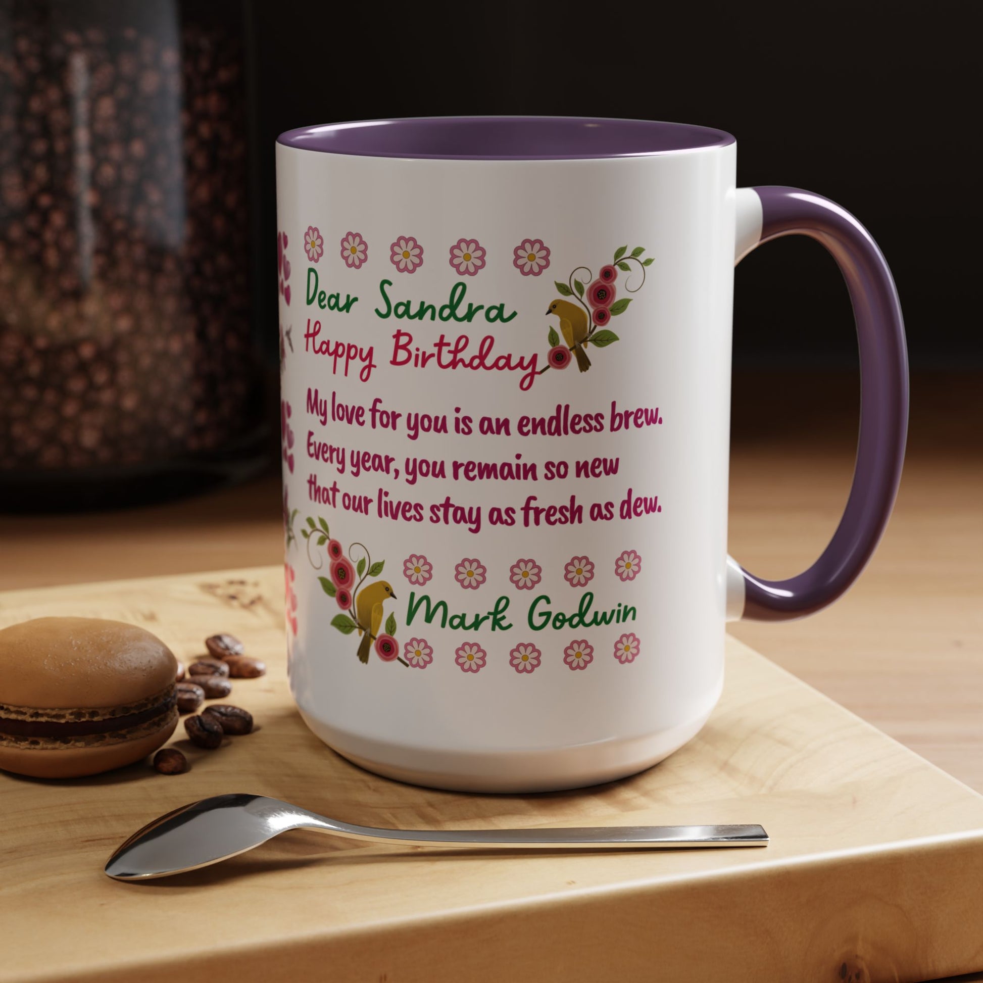 Personalized Birthday Mug for Wives. Personalized mug with floral design and birthday message on a wooden surface with coffee beans and a macaron.