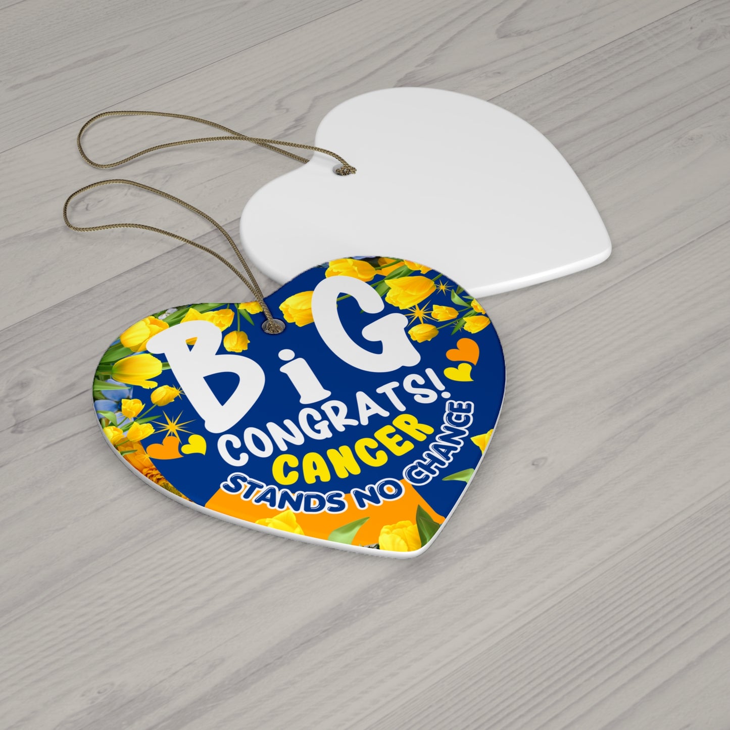 Cancer Motivational Ceramic Ornament of Victory. Heart-shaped decorative tag with floral design and text on a wooden surface