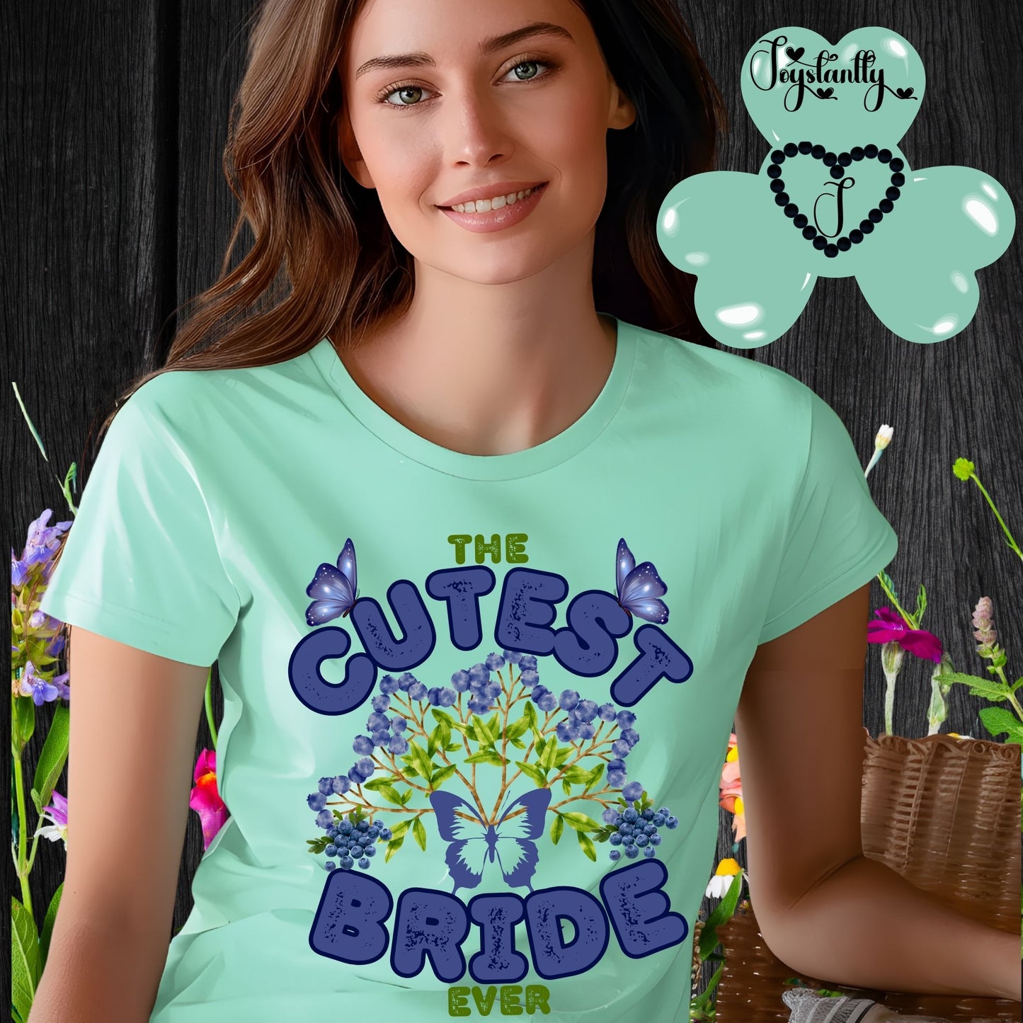 Woman wearing a mint green t-shirt with 'The Cutest Bride Ever' text and butterfly design, standing against a floral background.