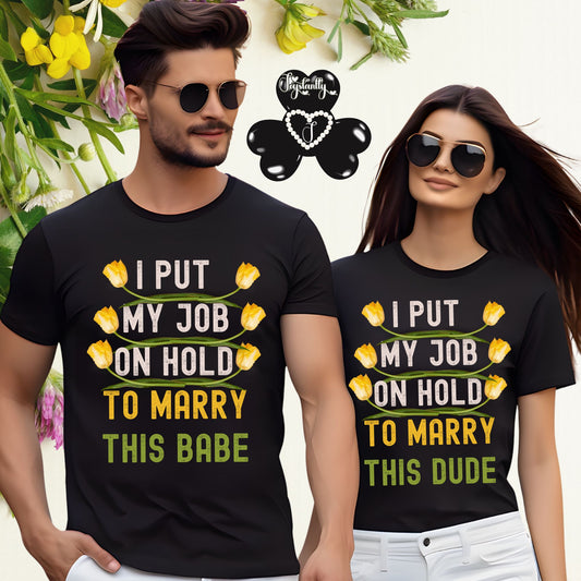 Two people wearing matching black t-shirts with humorous text and yellow tulip graphics.