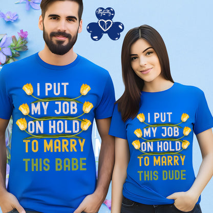 Two people wearing matching blue t-shirts with humorous text on a light blue background.
