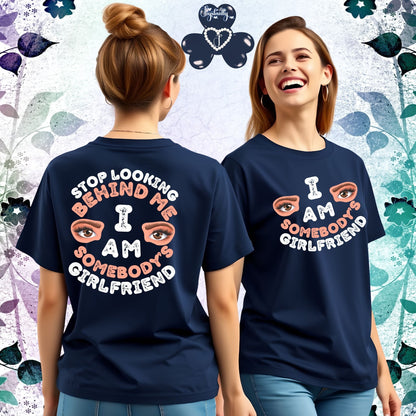Two women wearing navy blue t-shirts with a colorful design and text.
