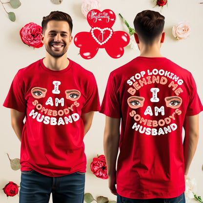 Red t-shirt with text and eye graphic worn by a person, with matching design on the back against a decorative background.