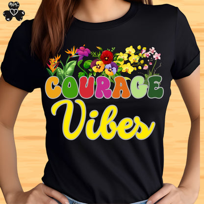 Motivational shirt. Black t-shirt with colorful 'Courage Vibes' design on a wooden surface