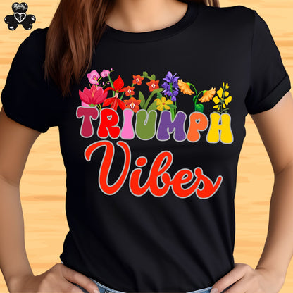 Motivational T-shirt for positive affirmations. Black t-shirt with colorful 'Triumph Vibes' design on a wooden surface