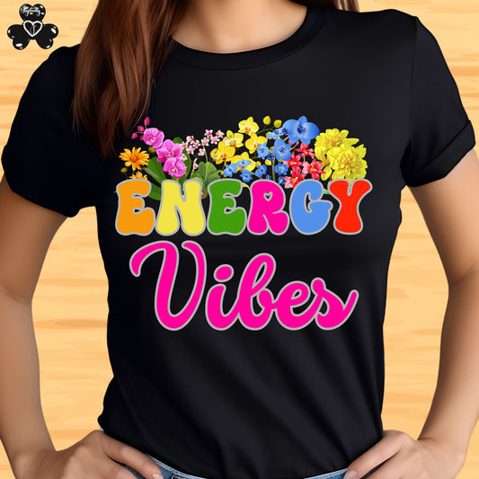 Motivational Shirts for Positive Affirmations. Black t-shirt with colorful 'Energy Vibes' design on a wooden surface