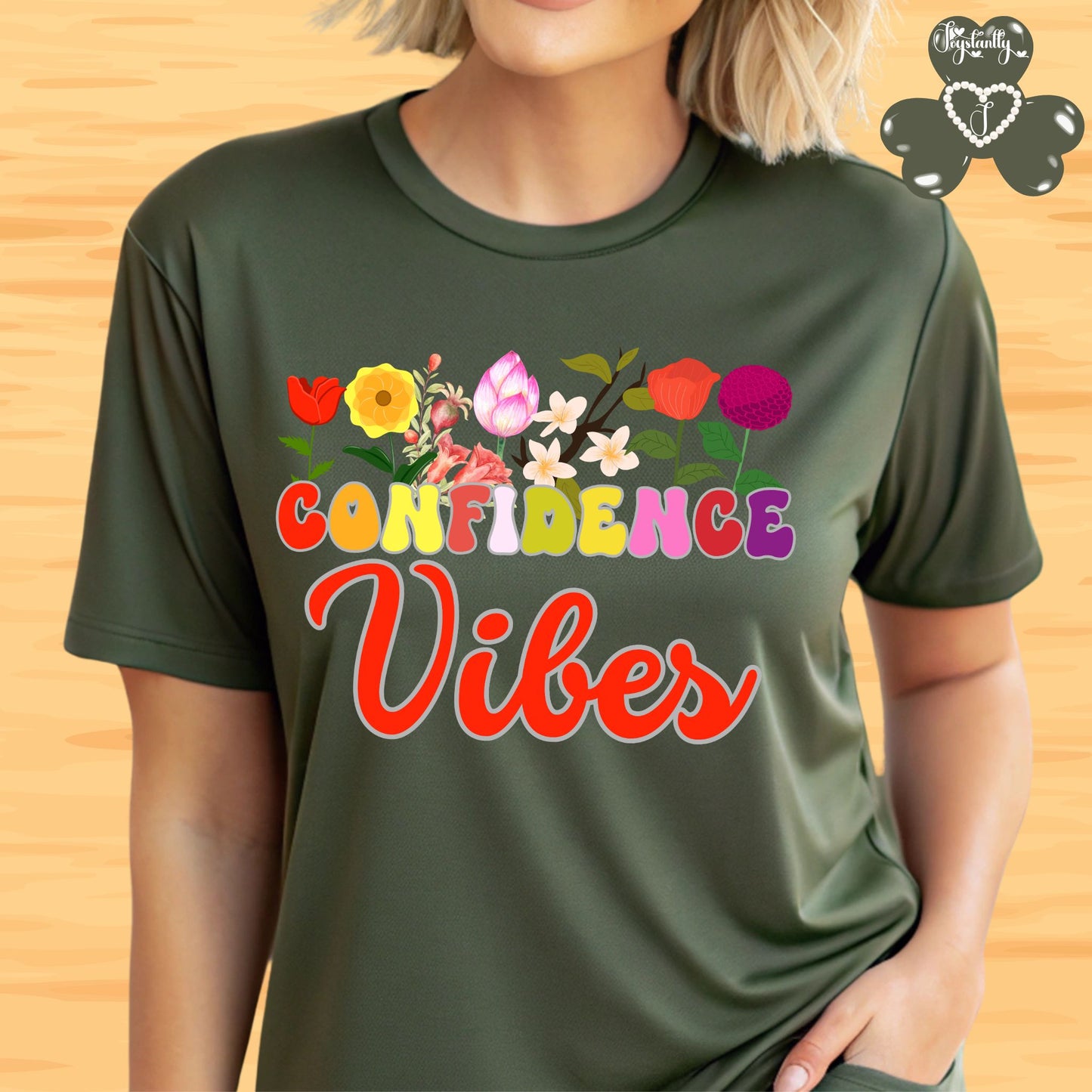 Motivational shirt. Person wearing a green t-shirt with 'CONFIDENCE Vibes' and colorful flowers on a wooden background