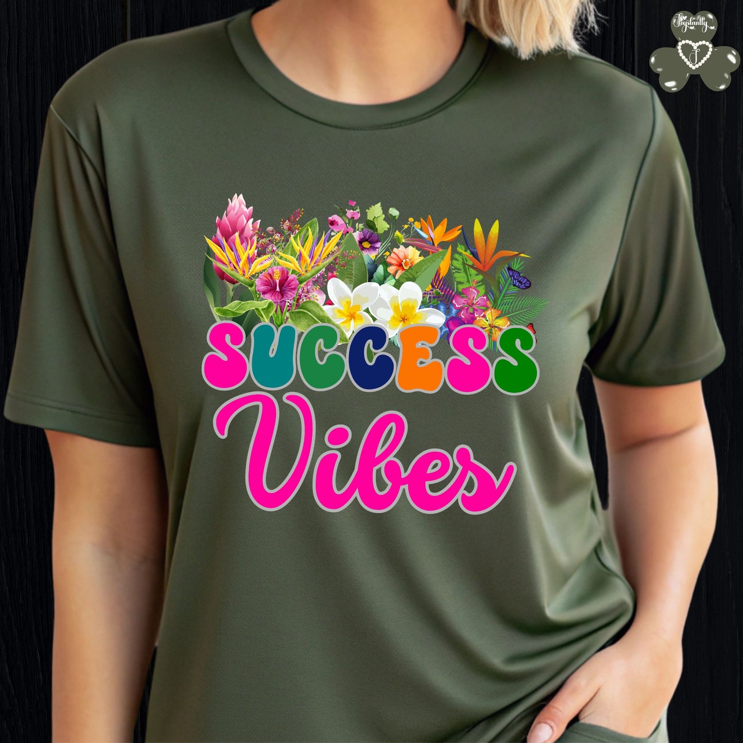 Motivational T-shirt for positive affirmations. Green t-shirt with colorful floral design and 'SUCCESS Vibes' text on a black background
