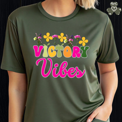 Motivational T-shirt for positive affirmations. Green t-shirt with 'Victory Vibes' and floral design on a black background