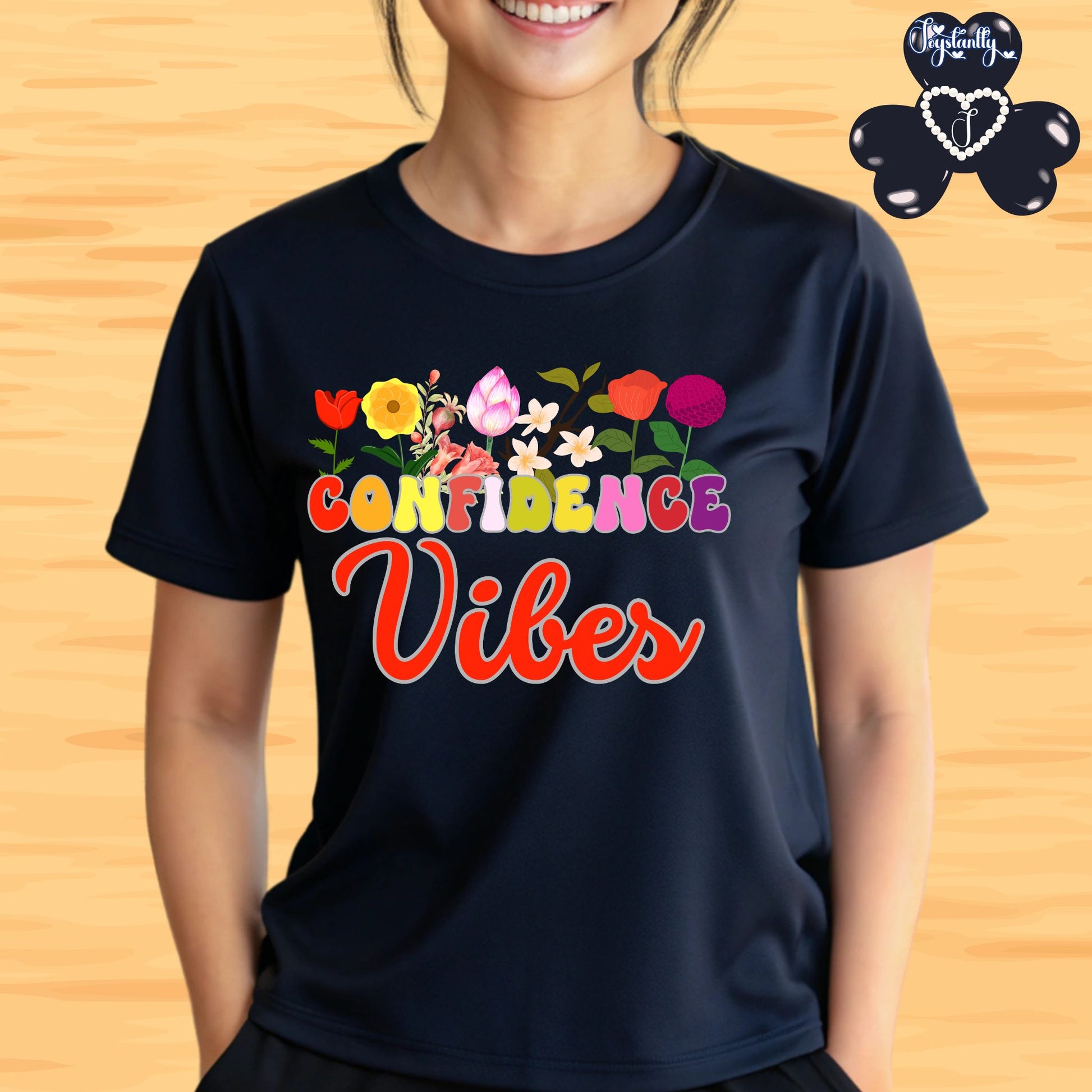 Motivational shirt. Person wearing a black t-shirt with colorful 'Confidence Vibes' design on a wooden background