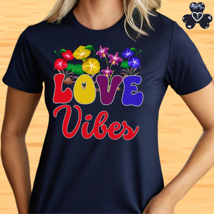 Motivational T-shirt for positive affirmations. Navy blue t-shirt with colorful 'LOVE Vibes' design on a wooden surface