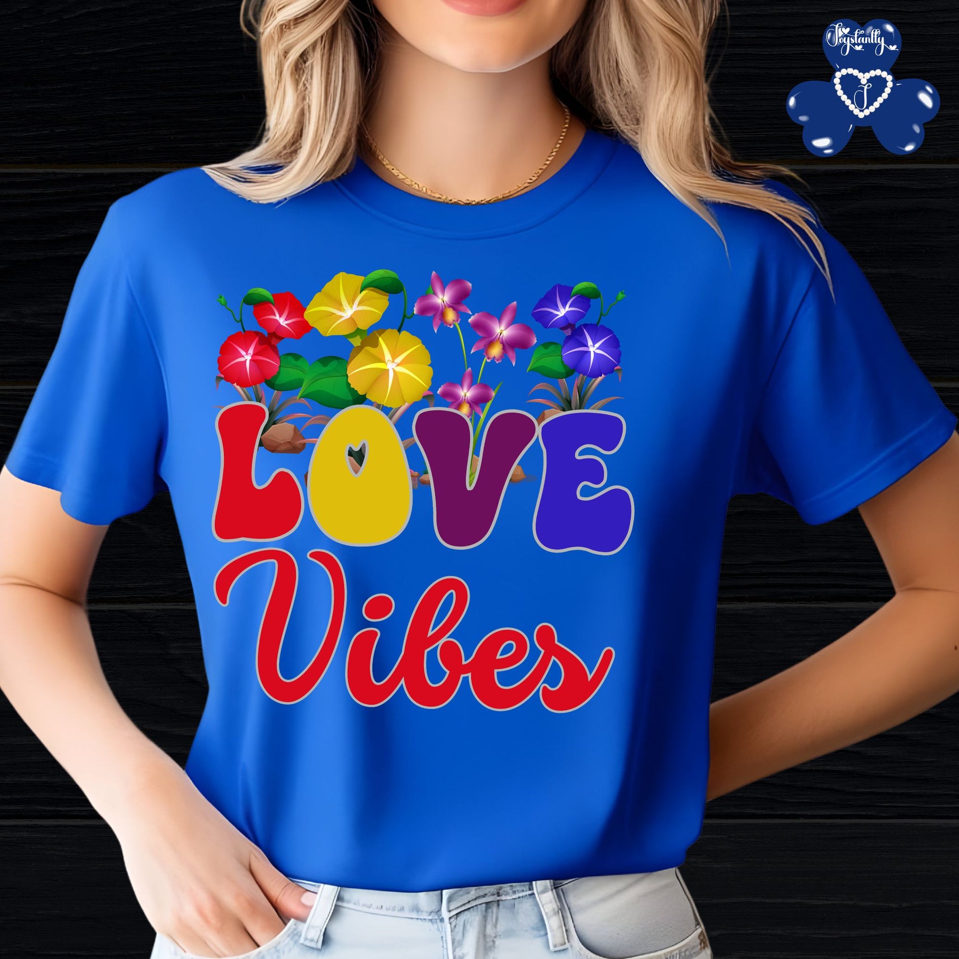 Motivational Shirts for Positive Affirmations. Person wearing a blue t-shirt with colorful 'LOVE Vibes' design
