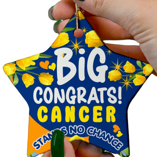 Cancer Motivational Ceramic Ornament of Victory. Star-shaped decorative item with 'Big Congrats! Cancer Stands No Chance' text and yellow flowers, held by a hand.