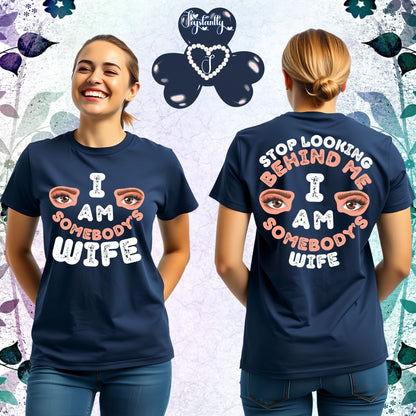 Two people wearing navy blue t-shirts with humorous text and eye graphics, on a decorative background.